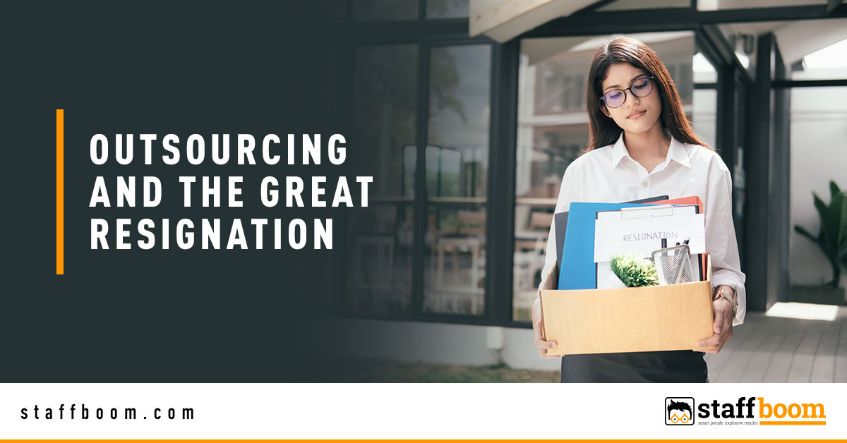 Employee Holding a Box - Banner Image for Outsourcing and the Great Resignation Blog
